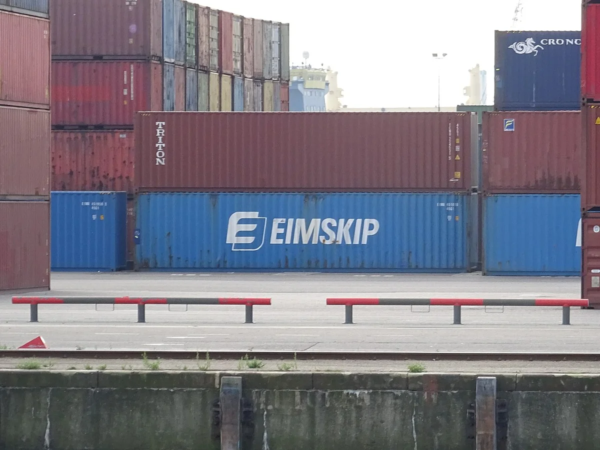 Red port cranes loading steel coils at a Chinese export terminal
